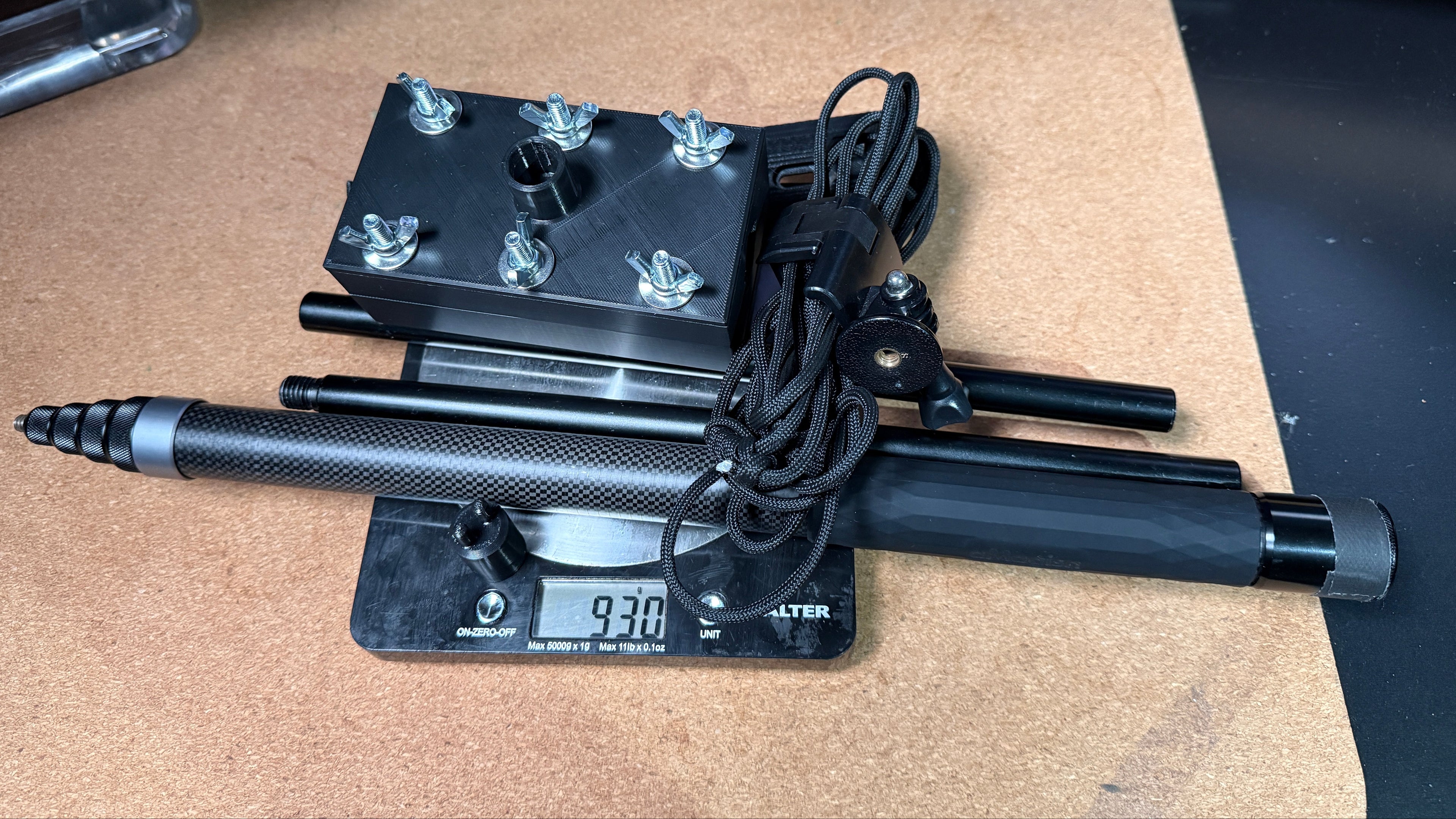 Black electronic scale with digital display on a wooden surface